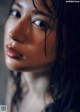 A close up of a woman with long black hair.