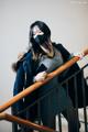 A woman wearing a face mask standing on a stairwell.